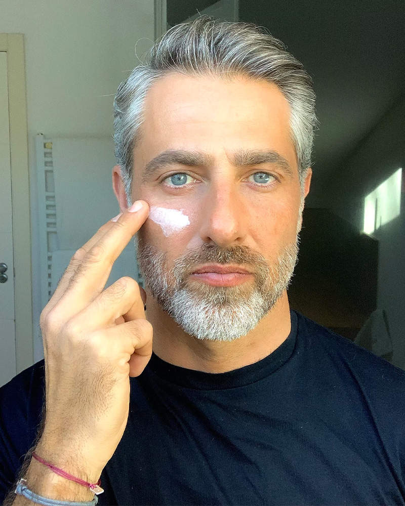 Man applying Particle Men’s Formula cream to face.