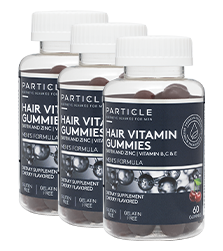 Three bottles of Particle Hair Vitamin Gummies standing in a row.