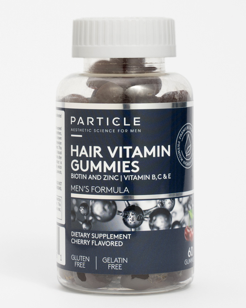 Plastic bottle containing Particle Hair Vitamin Gummies with white cap.