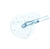 Pipette dispensing clear liquid onto a white surface.