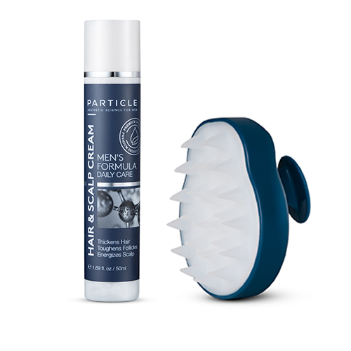 Particle Hair and scalp cream bottle beside scalp massage brush