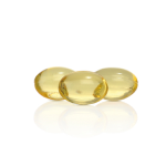 Three translucent yellow capsules lie on a white reflective surface.